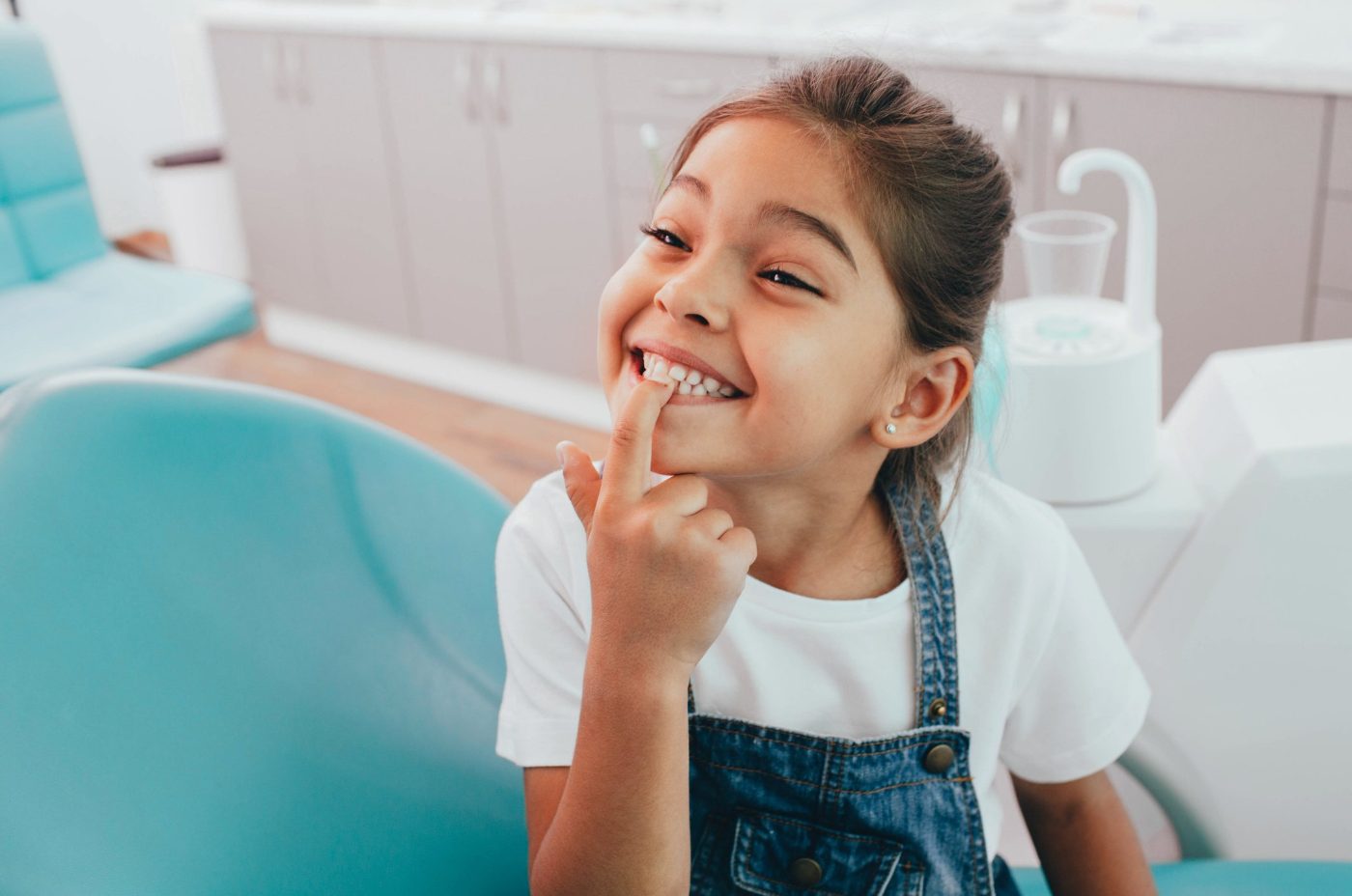 A young child in denim overalls