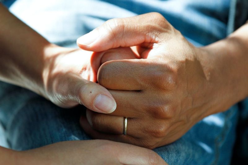 A doctor holding a patient's hand