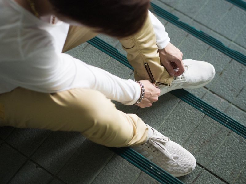 A man lacing up his shoes