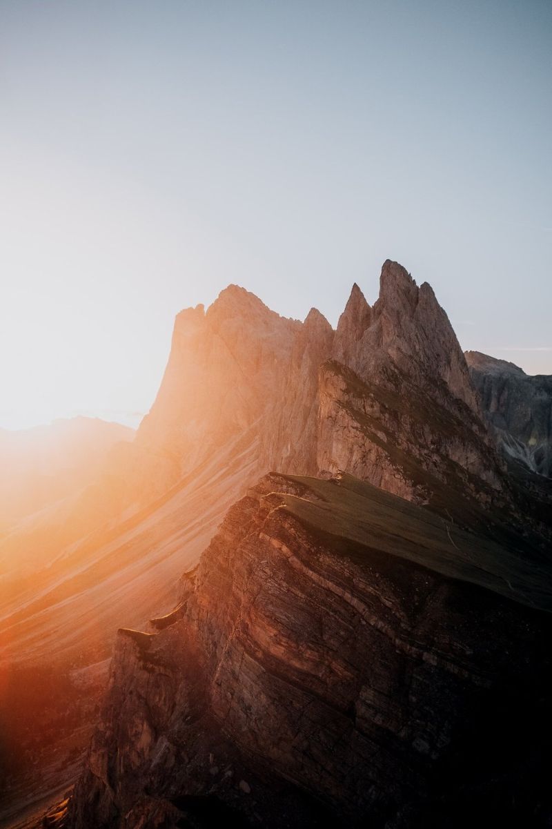 A sunrise shining on mountain peaks